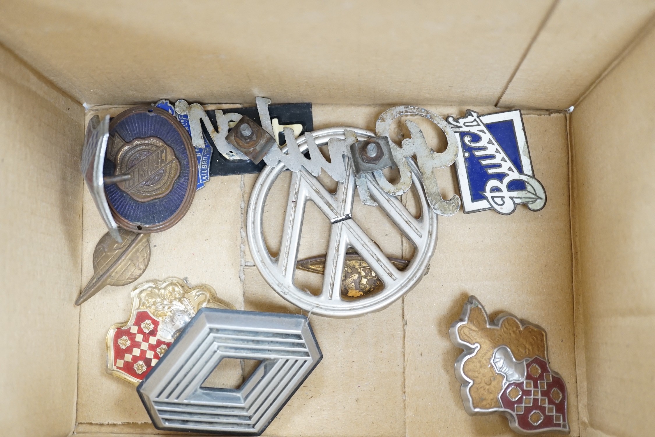 A mixed collection of RAC, AA and other automobile badges.